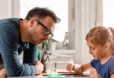 adult with child studying